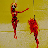 Doing Voodoo With Plastic Dolls. by DELCONE.